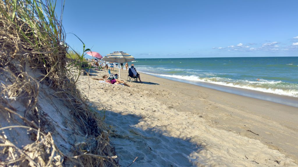 An eroded beach berm in Delray Beach, FL forces sunbathers into a small strip of sand in anticipation of a renourishment project, Oct. 2025. (Photo: Boca Daily News)