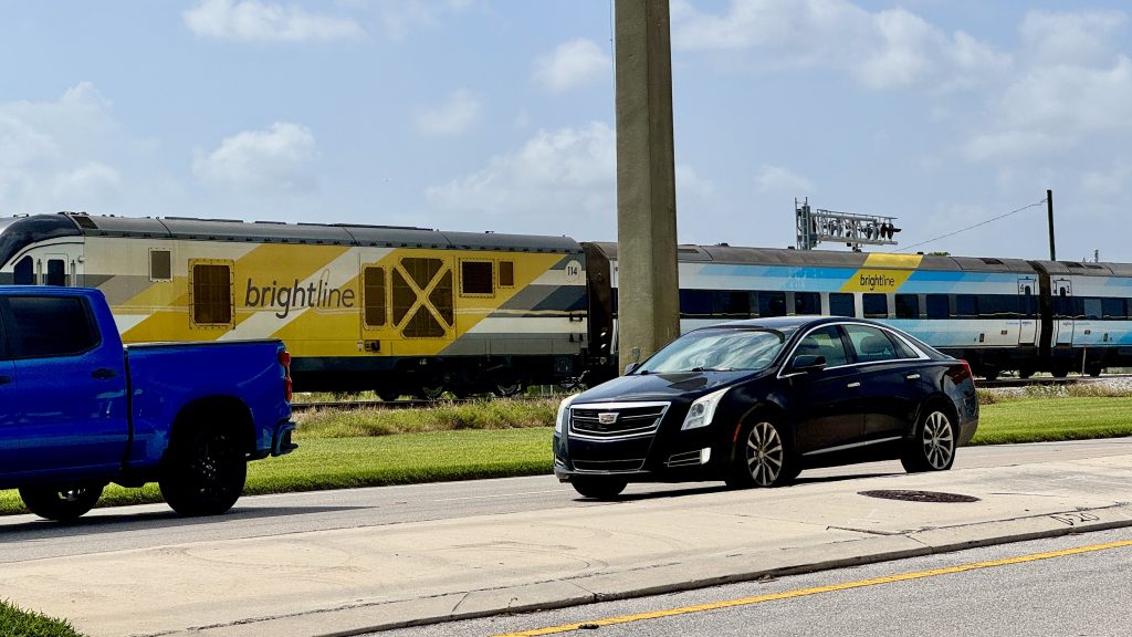 A Brightline train runs along the Florida East Coast Railroad tracks in Boca Raton. (Photo: Boca Daily News)
