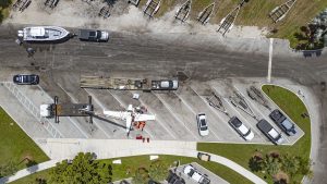A Piper Twin Comanche PA-39 (PA-30 variant) at a boat ramp in Boca Raton, FL, being prepared to be removed by a crane after landing in the ocean, Aug. 23, 2026. (Photo: Boca Daily News)