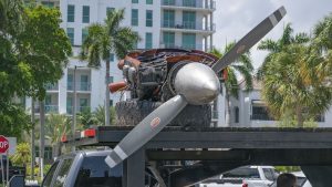 A Piper Twin Comanche PA-39 (PA-30 variant) at a boat ramp in Boca Raton, FL, being prepared to be removed by a crane after landing in the ocean, Aug. 23, 2026. (Photo: Boca Daily News)