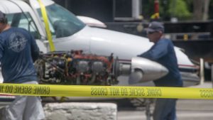 A Piper Twin Comanche PA-39 (PA-30 variant) at a boat ramp in Boca Raton, FL, being prepared to be removed by a crane after landing in the ocean, Aug. 23, 2026. (Photo: Boca Daily News)