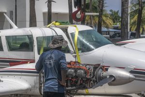 A Piper Twin Comanche PA-39 (PA-30 variant) at a boat ramp in Boca Raton, FL, being prepared to be removed by a crane after landing in the ocean, Aug. 23, 2026. (Photo: Boca Daily News)